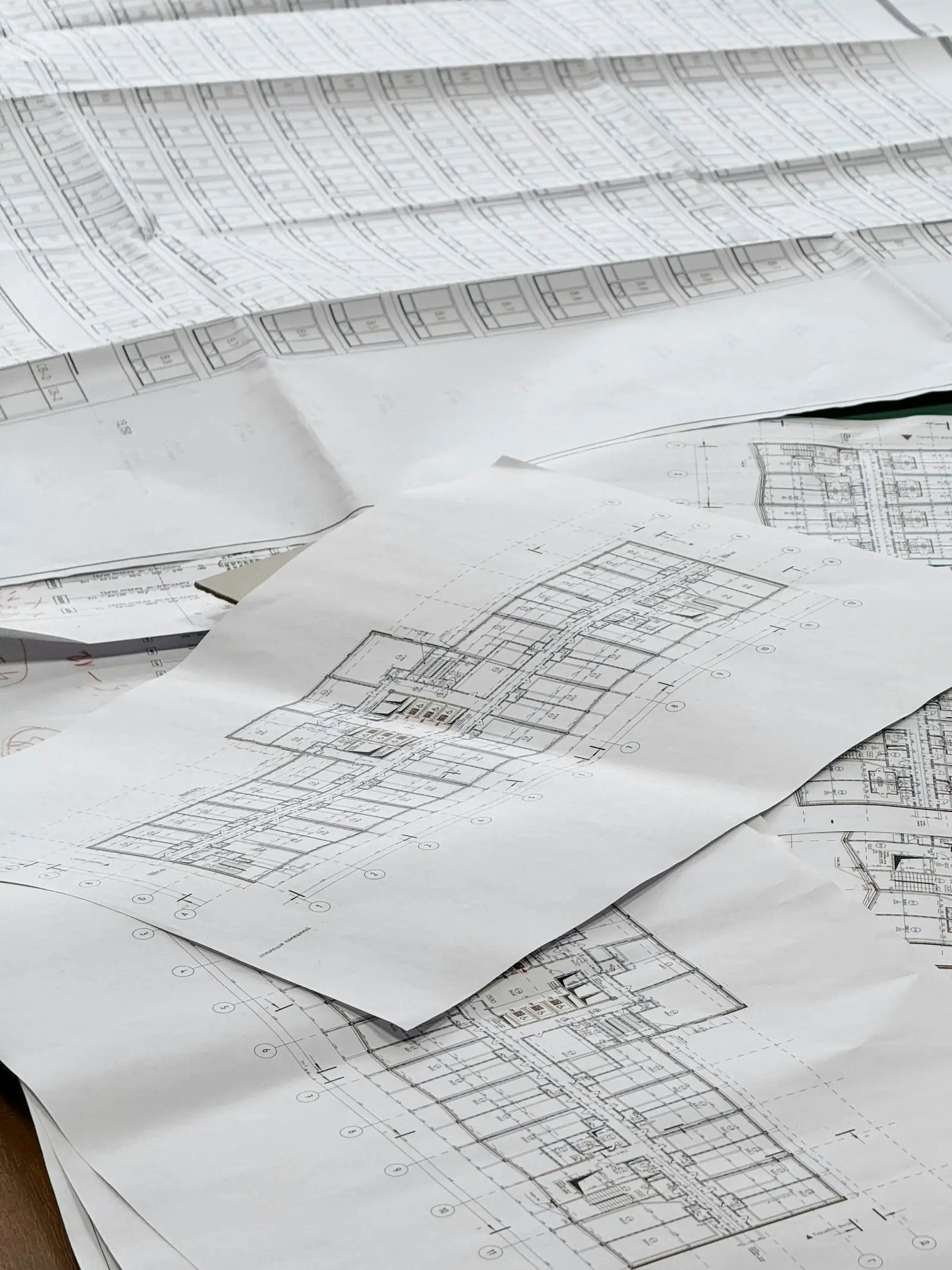 Architectural floor plans spread across a table